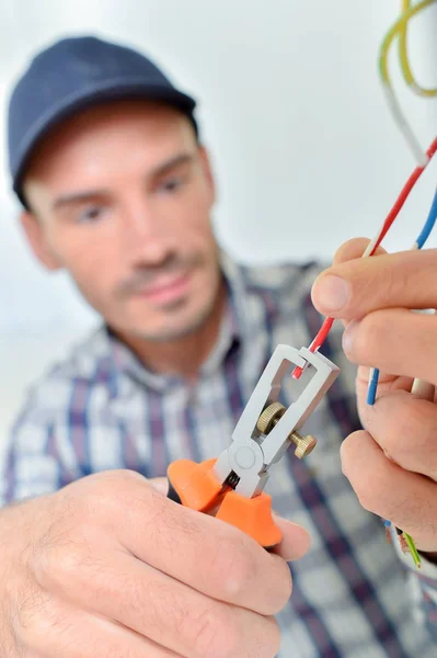 Electrician with cables on his hand standing — Stock Photo, Image