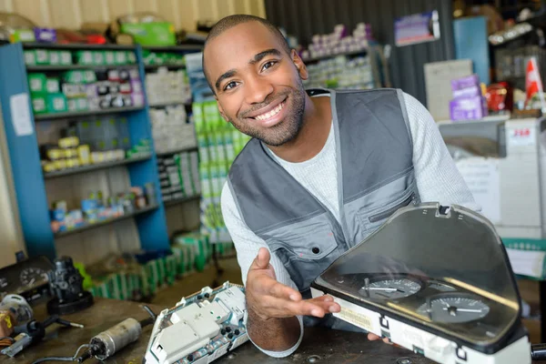 Mechanic with second hand scooter dashboard instruments — Stock Photo, Image