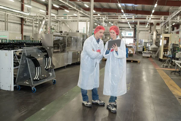 Happy two factory workers in uniform examining sample — Stock Photo, Image