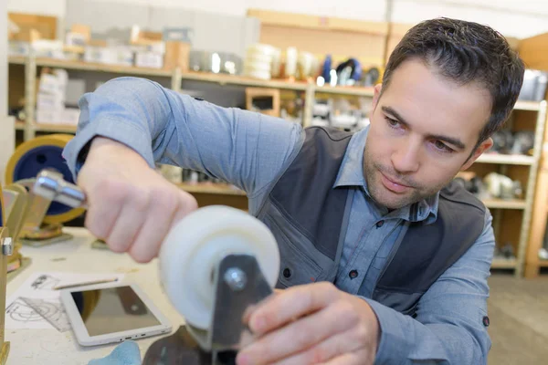 Mechanic repairing small wheels — Stock Photo, Image