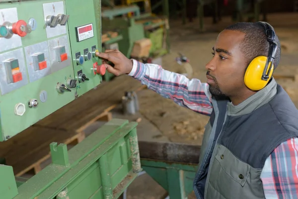 Mens controlerende industriële machine — Stockfoto