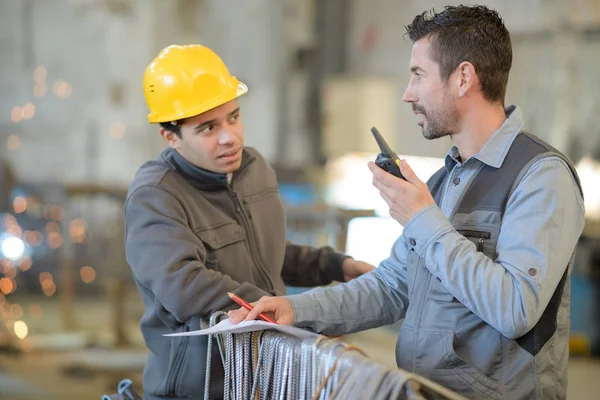 Female factory worker talking on the radio phone — Stock Photo, Image