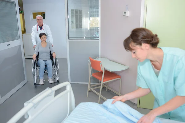 Vrouw wordt wielen in een ziekenhuis kamer — Stockfoto