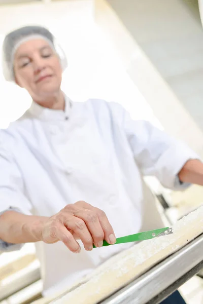 Scoring dough and apron — Stock Photo, Image