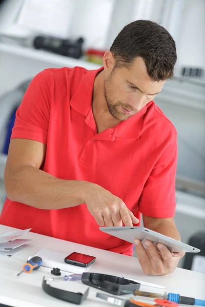 Handsome young male using tablet in the office — Stock Photo, Image
