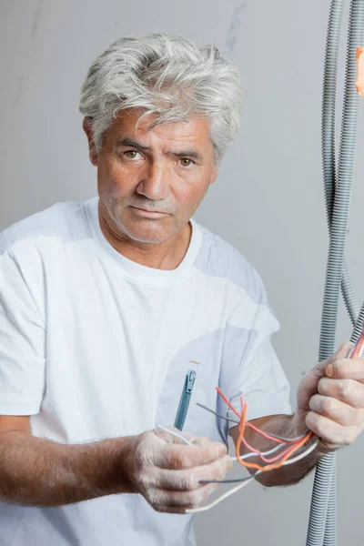 Electrician holding some wiring — Stock Photo, Image