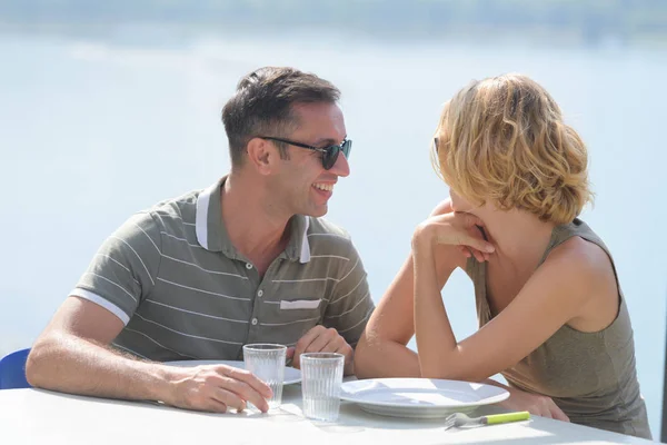 Young couple on terrace in sunset time near river — Stock Photo, Image