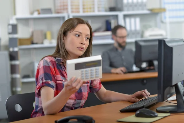 Vrouwelijke verkoper bedrijf elektrisch product — Stockfoto