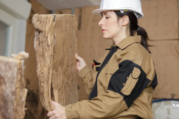 female worker working with insulation boards