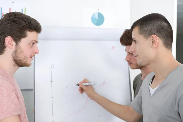 3 students writing on the board — Stock Photo, Image