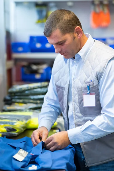 Man preparing order of work overalls — Stock Photo, Image