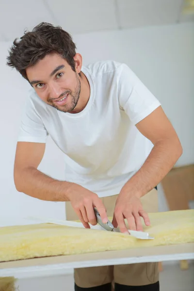 Plasterer cutting a foam — Stock Photo, Image