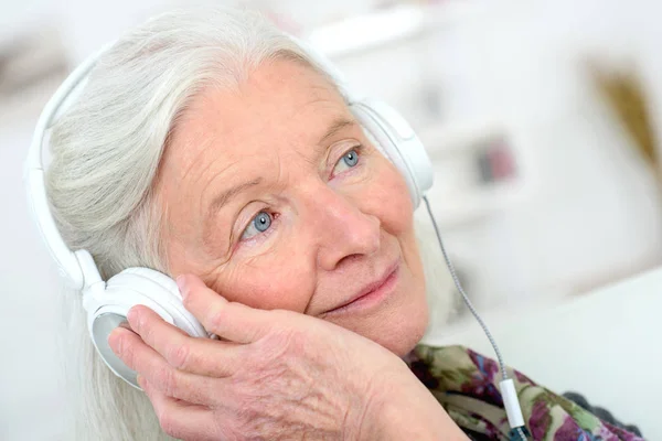 Anciana con auriculares — Foto de Stock