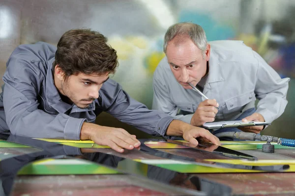 Material engineer being observed by the teacher — Stock Photo, Image