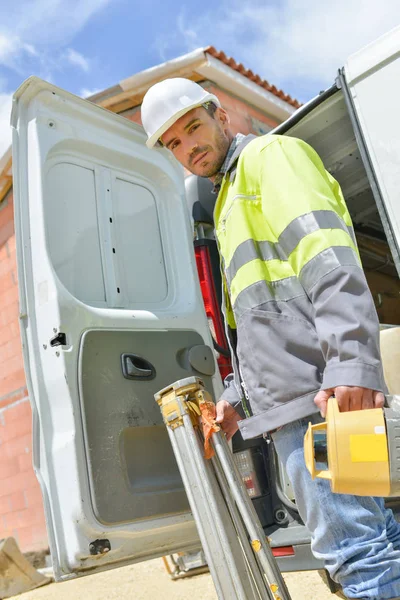 Industrial worker posing next to a utility van — Stock Photo, Image