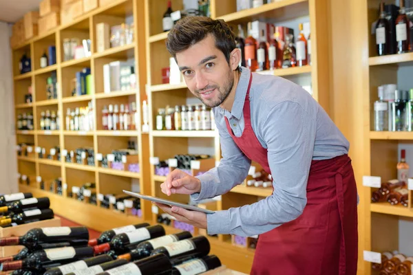 Jonge man aan het werk in wijn winkel — Stockfoto