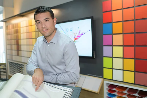 Salesman in furniture store — Stock Photo, Image