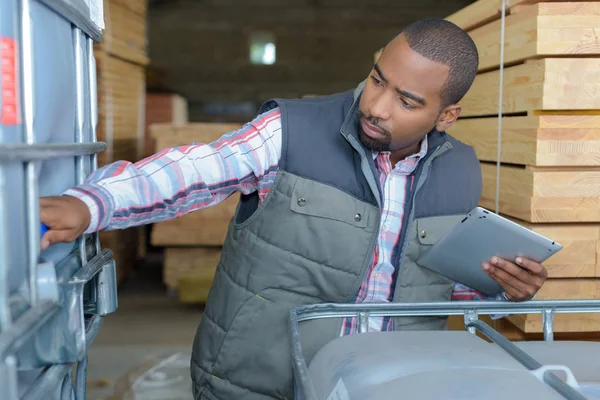 Worker holding tablet looking at vat — Stock Photo, Image