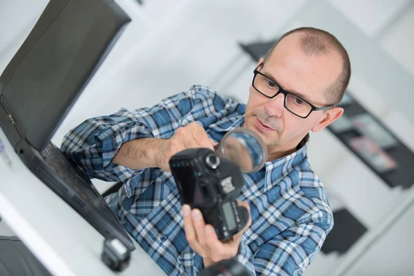 Worker on camera lens — Stock Photo, Image