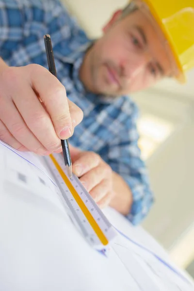 Architect rectifying  some plans at a site — Stock Photo, Image