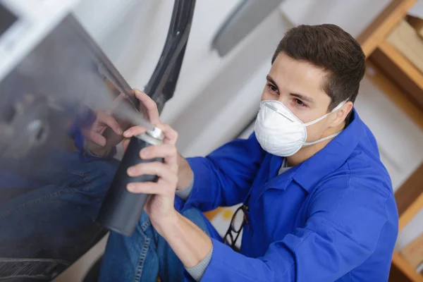 worker painting the car