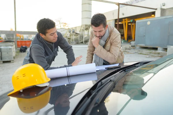 Men having a conversation outside an industrial factory — Stock Photo, Image