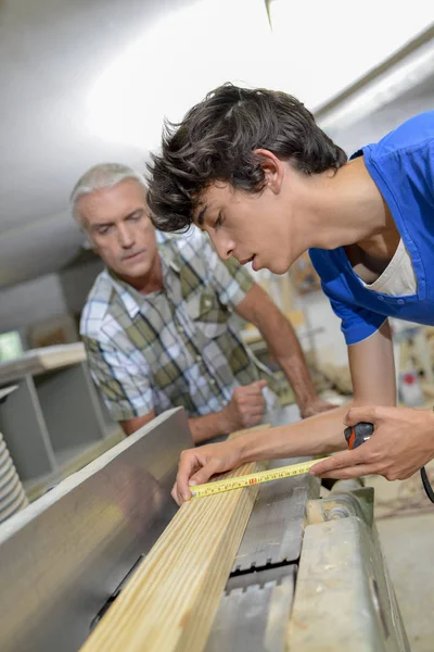 Carpinteiro assistindo trabalho aprendiz — Fotografia de Stock