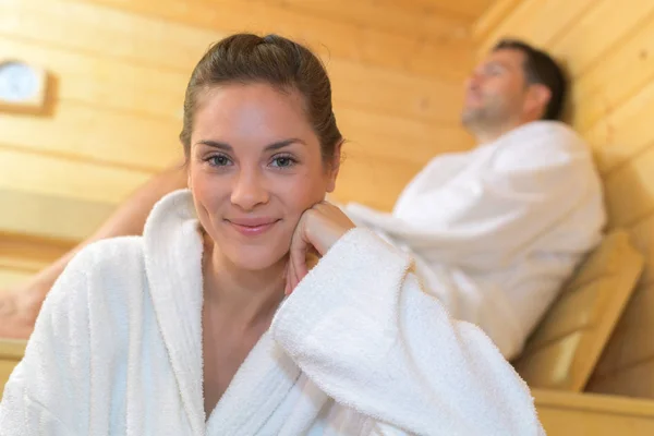 Happy couple enjoying the sauna together at the spa — Stock Photo, Image