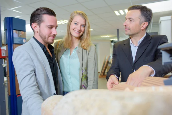 Couple regardant les tuiles de toit avec le représentant de la boutique — Photo