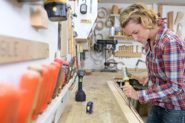 Confident female carpenter with a chisel — Stock Photo, Image