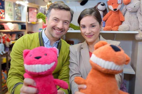 Parents-to-be shopping choosing plush for their kid — Stock Photo, Image