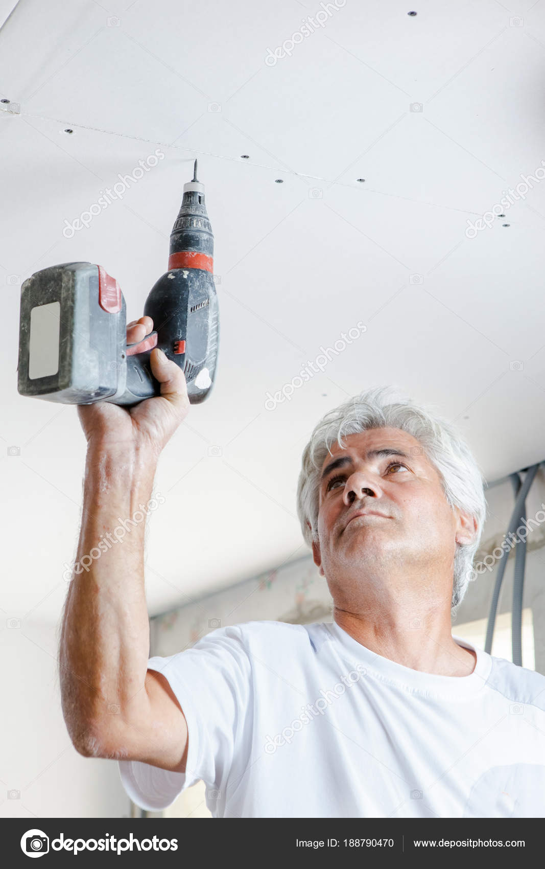 Man Screwing Plasterboard To Ceiling Stock Photo C Photography33