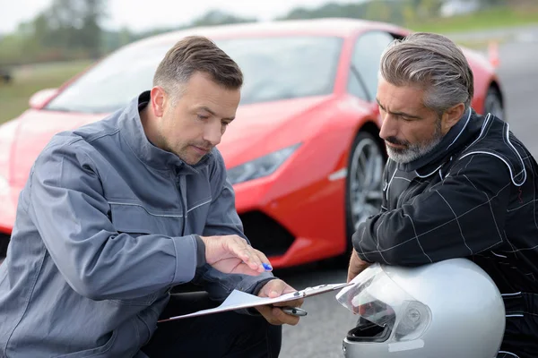 Professional car driver with coach — Stock Photo, Image