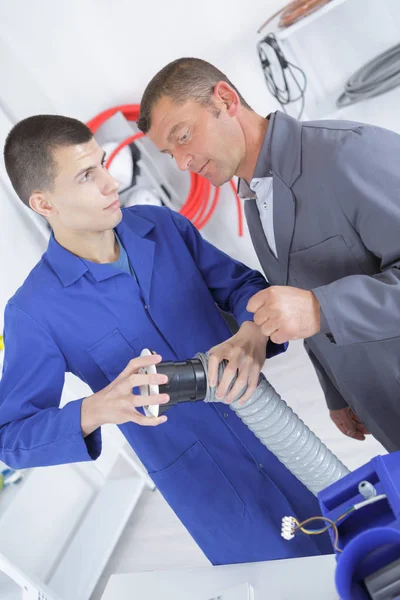 Lehrling hält Schlauch in der Hand — Stockfoto