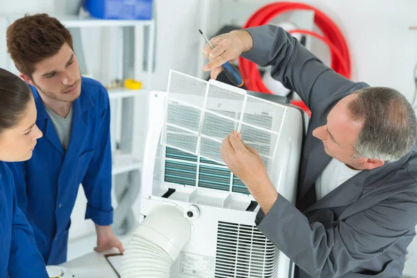 Konditionierungstechniker mittleren Alters mit Studenten — Stockfoto