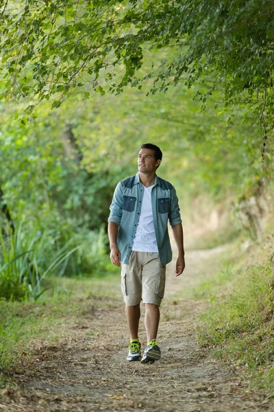 Young man walking in the park — Stock Photo, Image