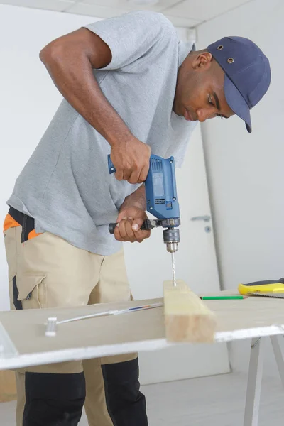 Man drilling into wood — Stock Photo, Image
