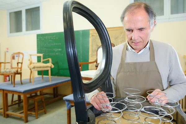 Senior Arbeiter repariert Stuhl in seiner Werkstatt — Stockfoto