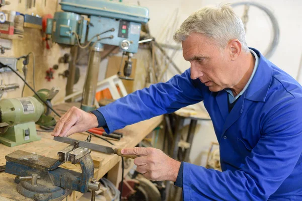 Senior craftsman working in shed — Stock Photo, Image