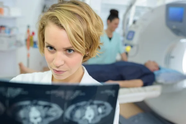 Giovane medico donna guardando i polmoni immagine a raggi X — Foto Stock