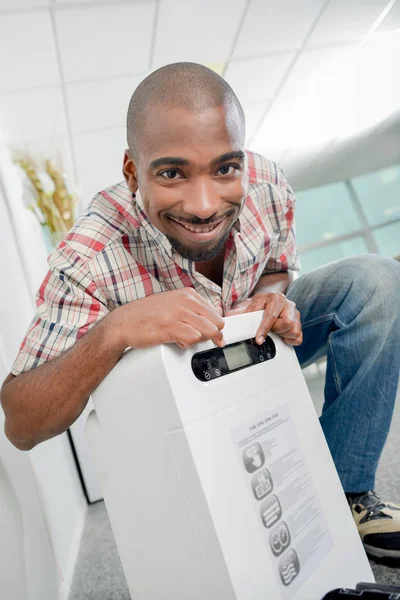 Man with apparatus and african — Stock Photo, Image