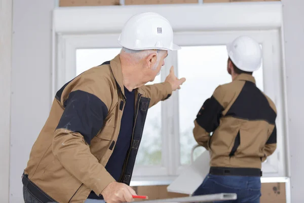 Men fitting new pvc window