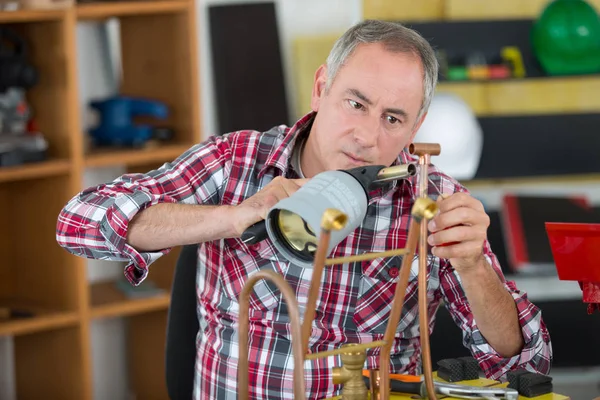 Workerusing blowtorch for soldering copper fittings — Stock Photo, Image