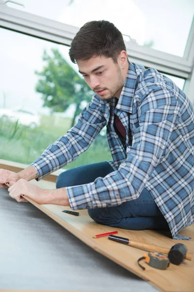 Jovem montagem novo piso laminado — Fotografia de Stock