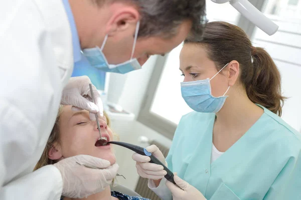 Стоматолог женщина, работающая с пациентом — стоковое фото
