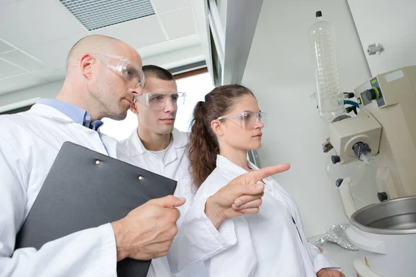 Enseignant montrant l'équipement aux étudiants en sciences — Photo