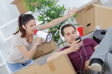 man online while angry woman calling him through a megaphone clipart