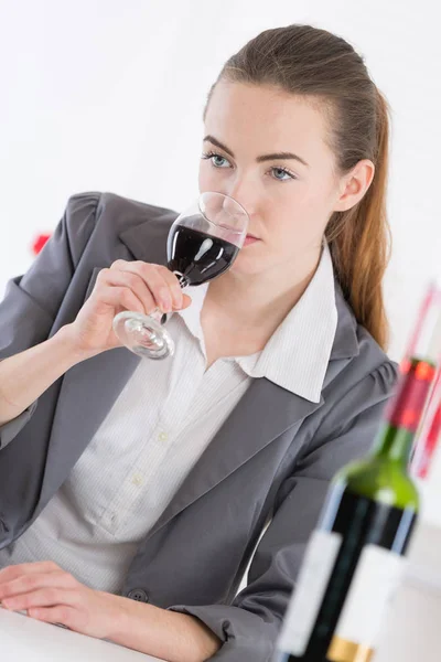 Pretty young woman drinking red wine at restaurant — Stock Photo, Image