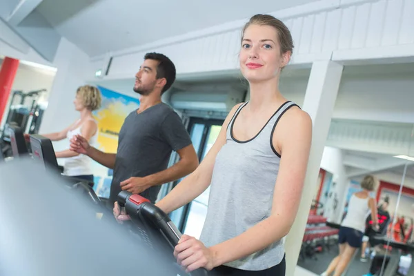 Gente corriendo en máquina cinta de correr en gimnasio de fitness —  Fotos de Stock