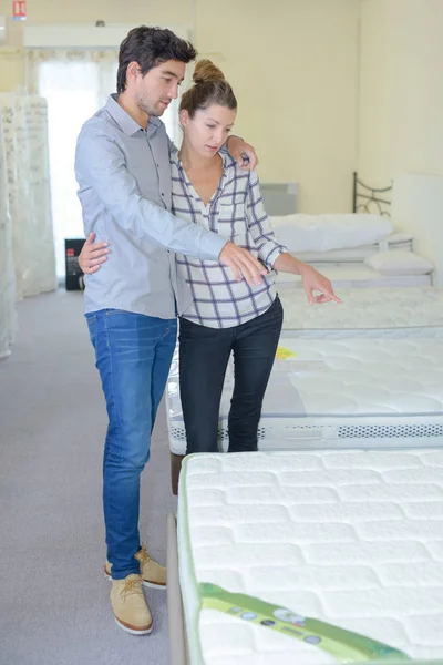 Couple shopping for mattress — Stock Photo, Image